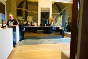 When entering the building from the front entrance (Keizersgracht street), you will find the reception on the right. The reception desks are high, though staff can walk around to the front to greet visitors.